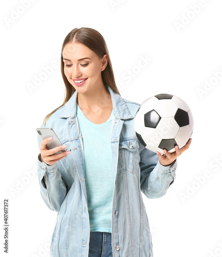 Foto Beautiful woman with mobile phone and soccer ball on white background
