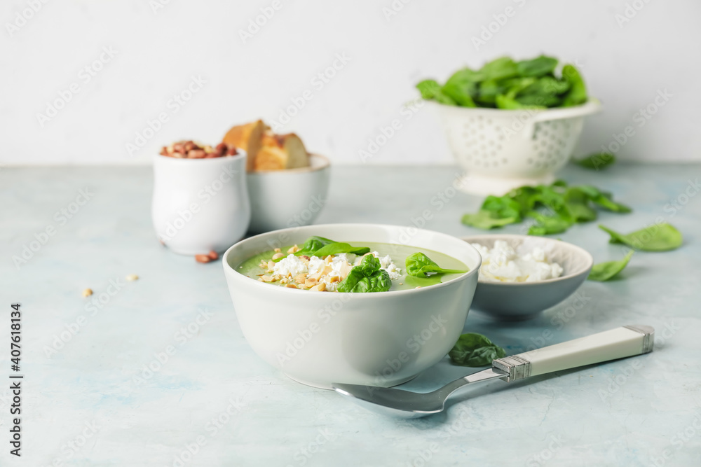 Bowl with tasty spinach soup on light background Bowl with tasty spinach soup on light background