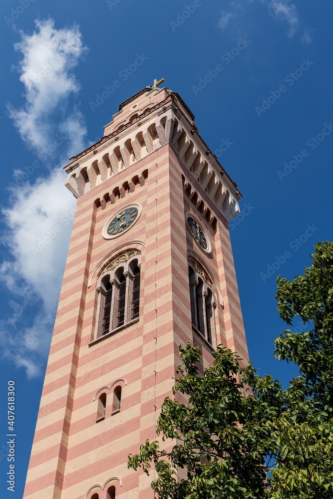 Obraz premium The restored high tower with a clock and a bell at the territory of The Church of Holy Transfiguration in Pancevo, Serbia