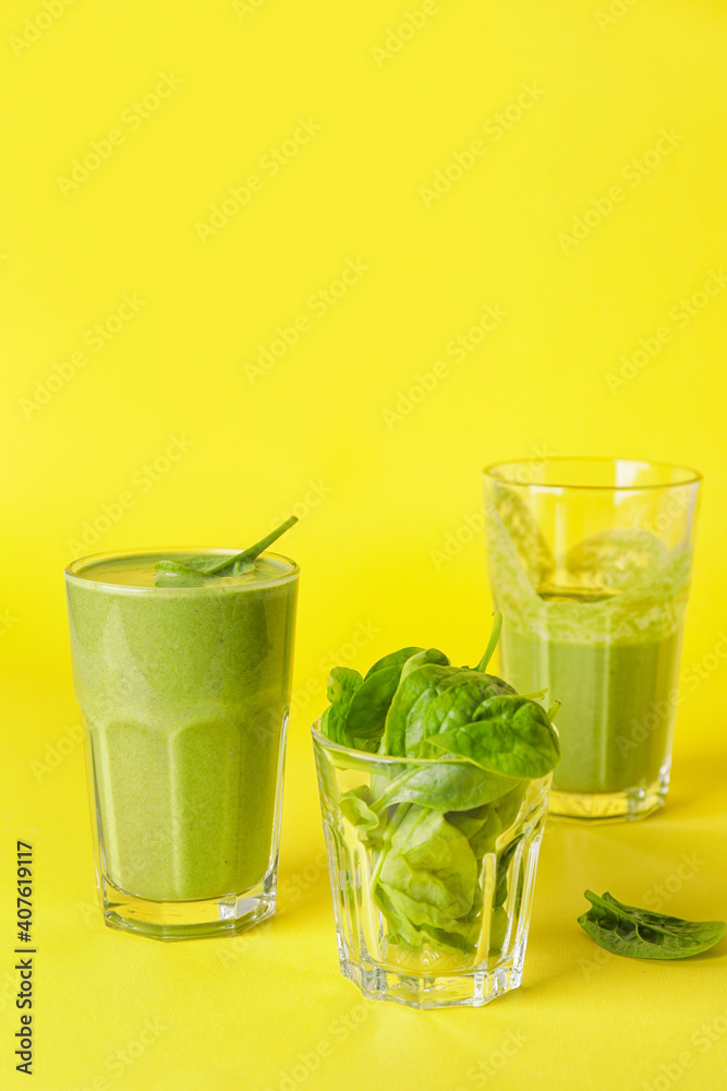 Glasses of healthy spinach smoothie on color background Glasses of healthy spinach smoothie on color background