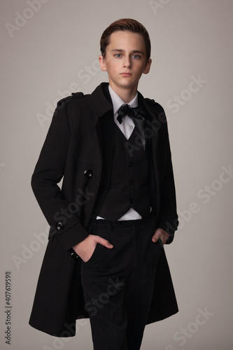 teen boy in stylish black coat