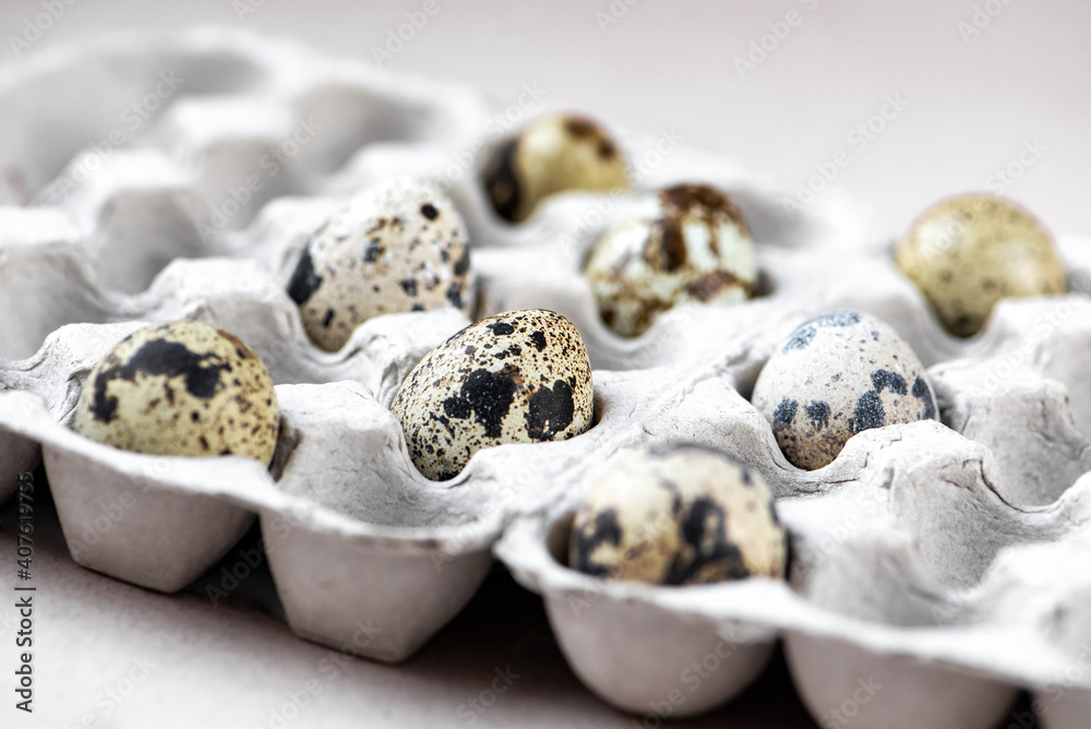 Quail spotted eggs in hald empty cardboard box. Organic eco food, Easter holiday. Selective focus
