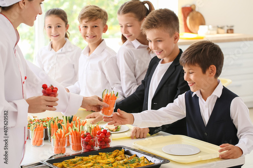 Pupils receiving lunch in school canteen
