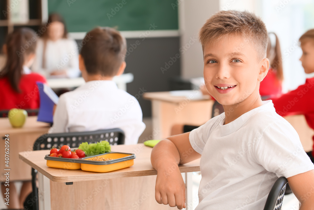 Schoolboy having healthy lunch in classroom Schoolboy having healthy lunch in classroom