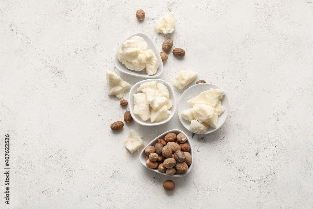 Shea butter and nuts on light background Shea butter and nuts on light background