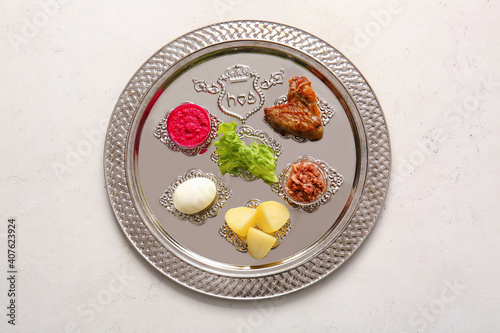 Passover Seder plate with traditional food on white background photo