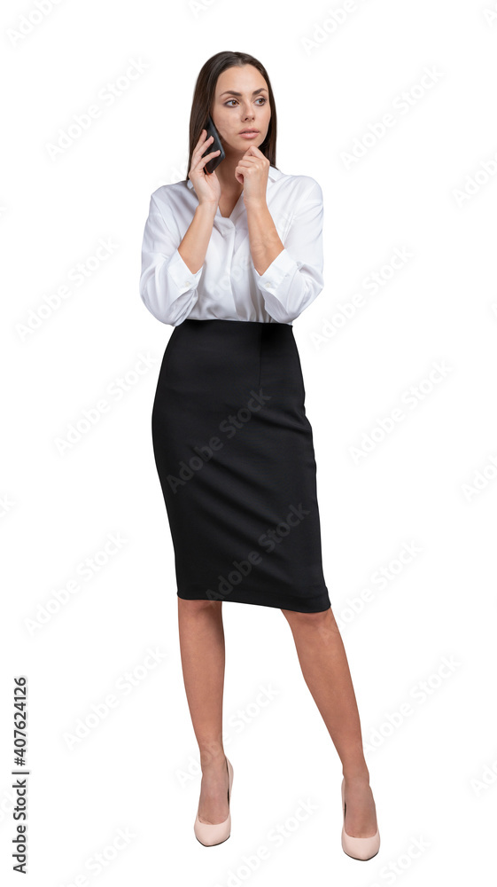 Young businesswoman in white shirt and black skirt, full length, thinking talking on the phone. Female office manager isolated over white background talking on the phone Young businesswoman in white shirt and black skirt, full length, thinking talking on the phone. Female office manager isolated over white background talking on the phone