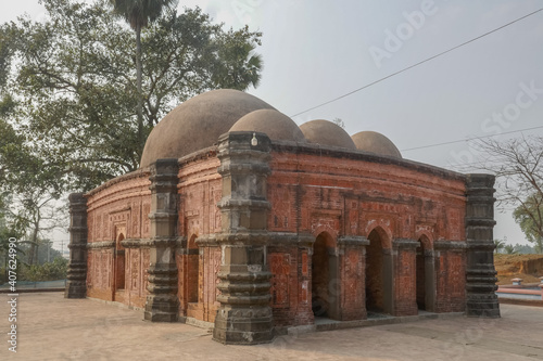 Side view of beautiful medieval stone and brick with terracotta carving Sura mosque in Ghoraghat, Dinajpur district, Bangladesh