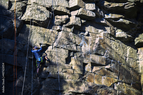 Rock climber is scrambling up a temple rock. High quality photo photo