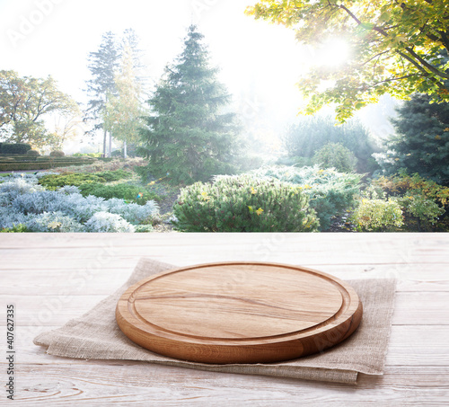 Napkin and board for pizza on wooden desk. Summer background.
