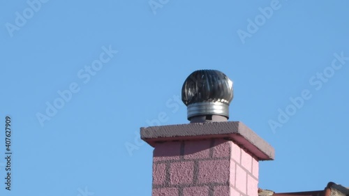 A chimney with with revolving rotating cowl cap, installed prevention for rodent entry to home/attic/building photo
