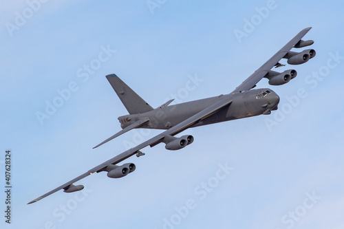 Canvas Print B52 Bomber turns towards the camera against a blue sky
