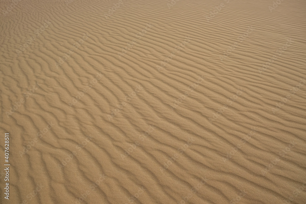 Beautiful view of rippled sandy surface in desert as background Beautiful view of rippled sandy surface in desert as background