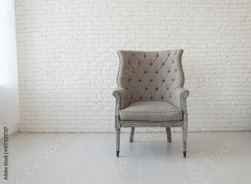 light gray armchair in an empty room