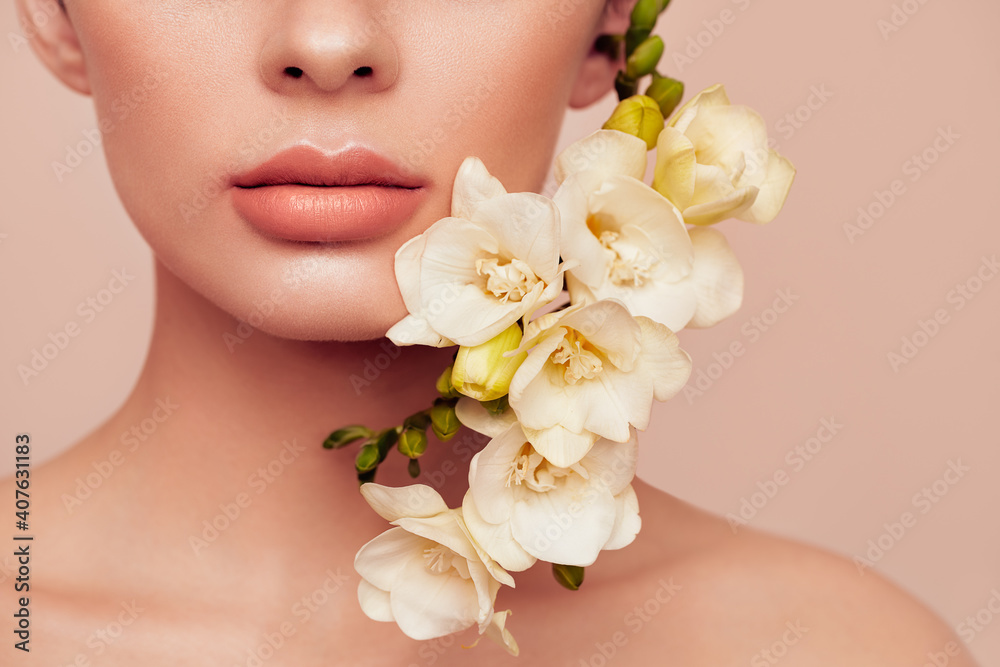 Beautiful model with a flower. Perfect woman face makeup close up Lipstick Beautiful model with a flower. Perfect woman face makeup close up Lipstick