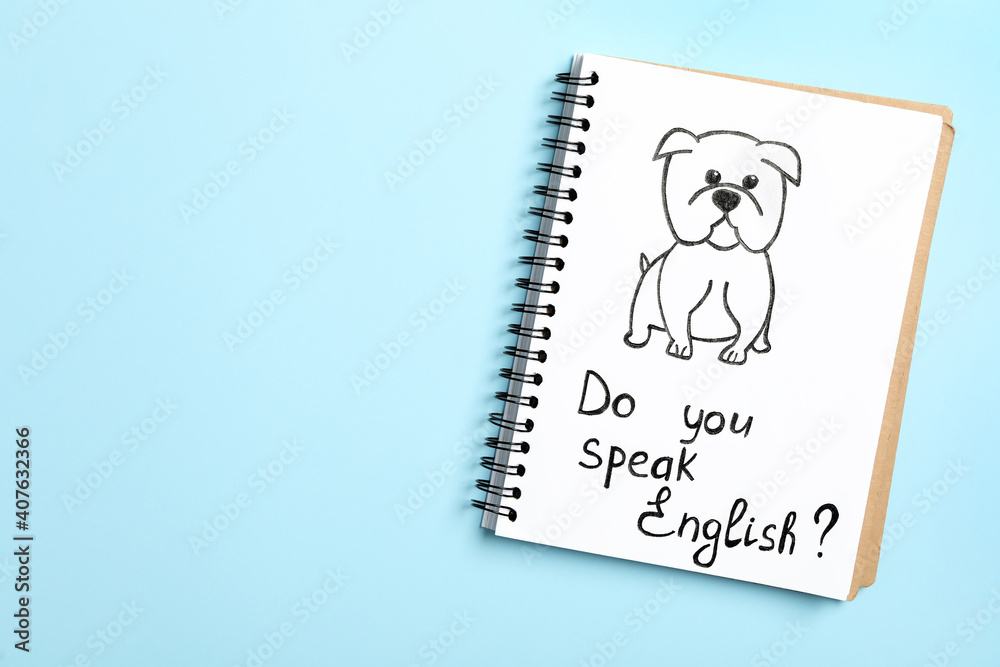 Notebook with question Do You Speak English on light blue background, top view. Space for text Notebook with question Do You Speak English on light blue background, top view. Space for text