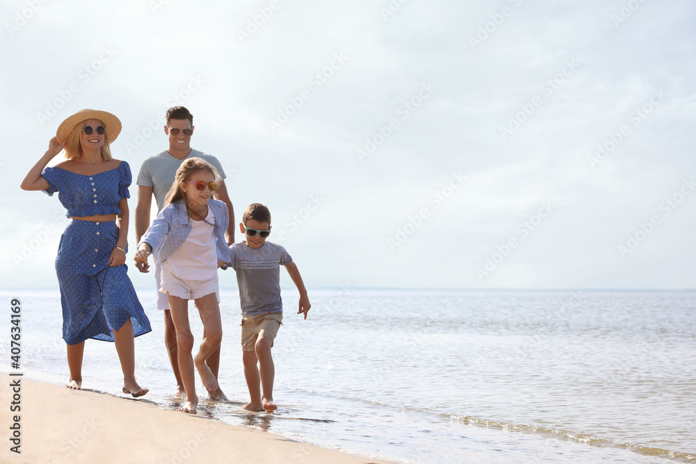 Happy family at beach on sunny summer day