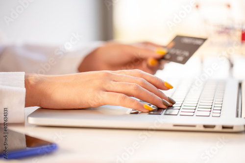 Fototapeta Naklejka Na Ścianę i Meble -  Online payment,Woman's hands using credit card and laptop for online shopping at home. Cyber Monday online shopping Concept