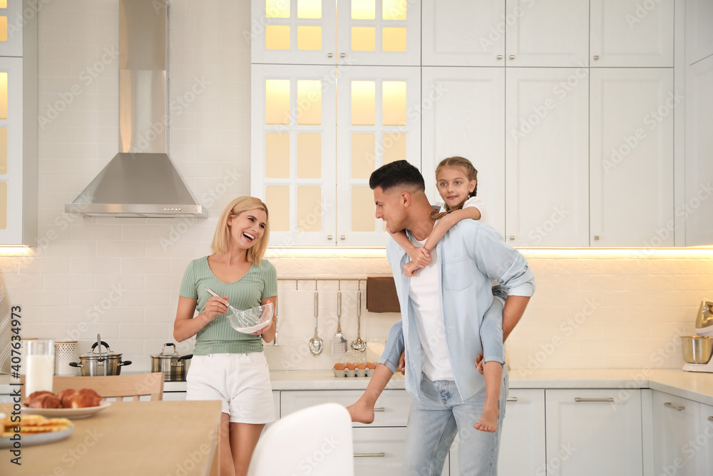 Happy family cooking together in modern kitchen Happy family cooking together in modern kitchen