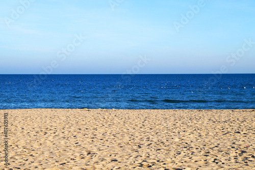 empty sandy beach, sea and clear sky, landscape for background © Anna