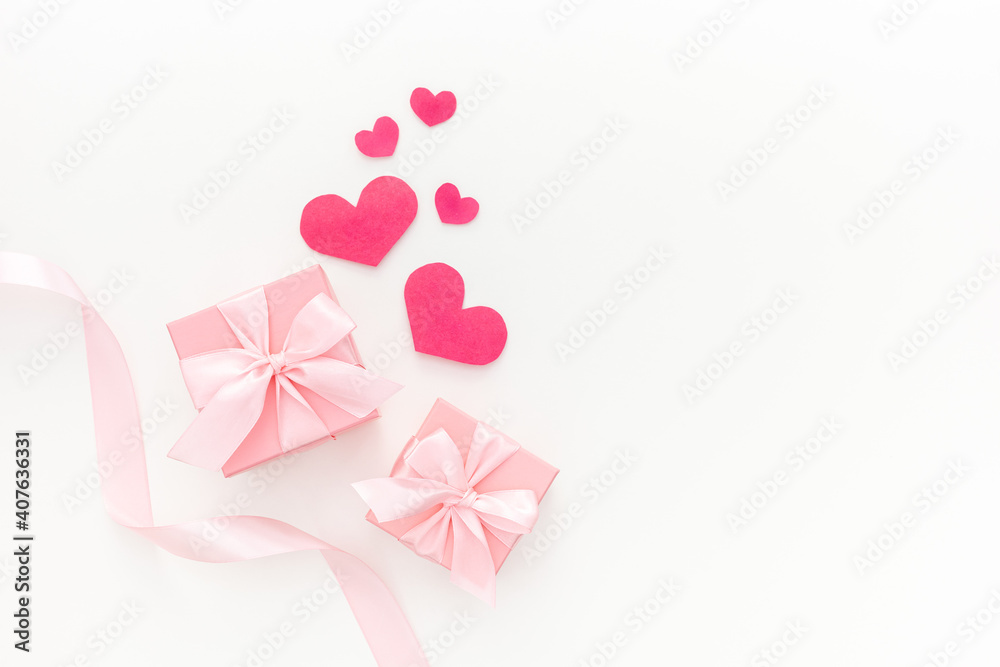 Composition of pink two gift boxes with ribbon and hearts