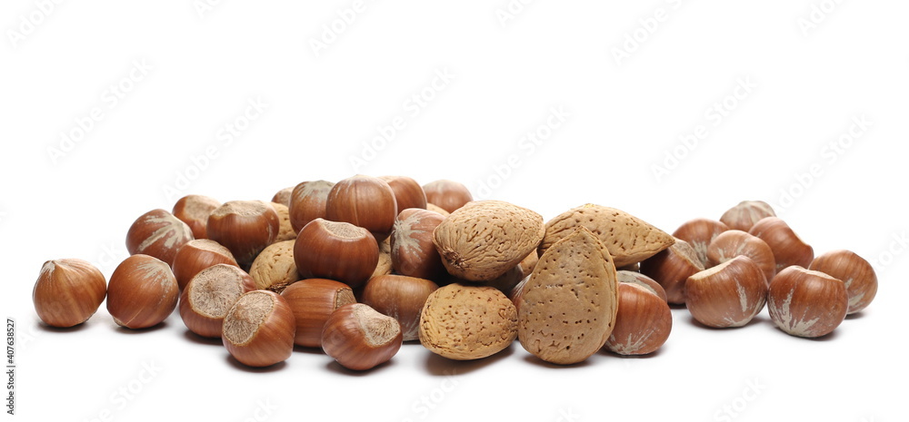 Hazelnuts and almonds, nuts pile isolated on white background Hazelnuts and almonds, nuts pile isolated on white background