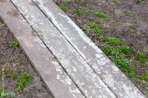 Drops and splashes from concrete on a wooden board