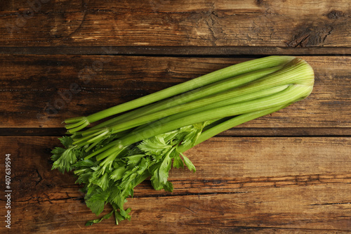 Fresh ripe green celery on wooden table, top view