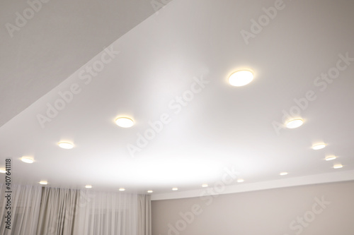 White stretch ceiling with spot lights in room photo