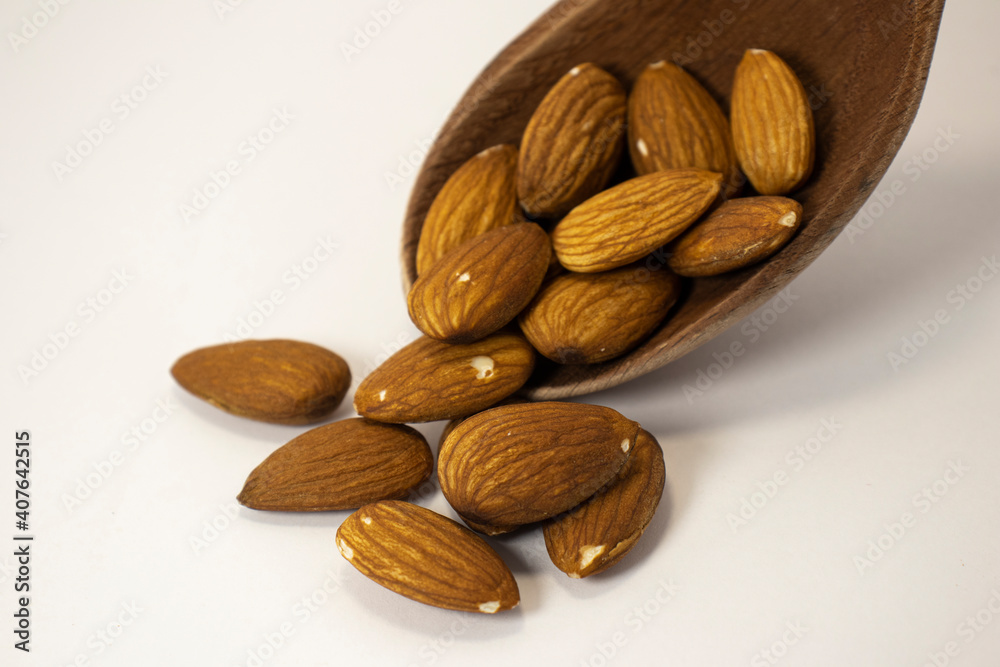 nuts in spoon on white isolated background with copy space