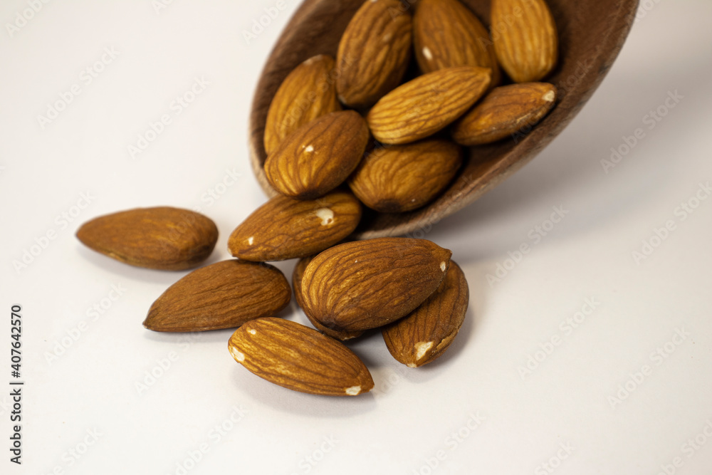 nuts in spoon on white isolated background with copy space