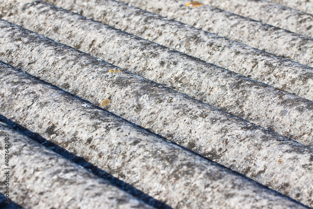 Detail of an old aged dangerous roof made of corrugated asbestos panels - one of the most dangerous materials in buildings and construction industry called hidden killer