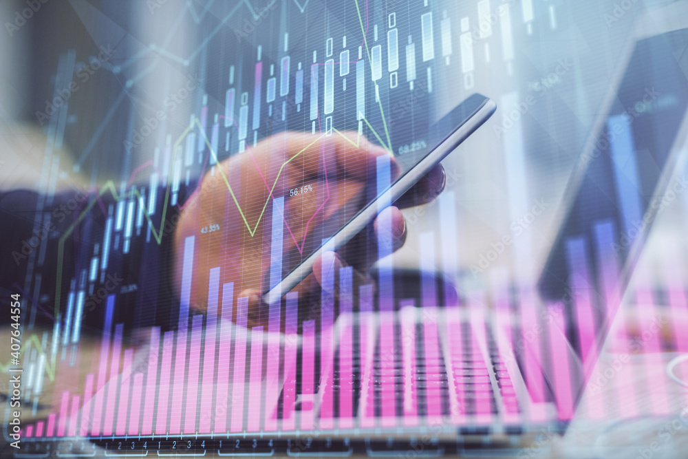 Double exposure of man's hands holding and using a phone and financial graph drawing. Analysis concept. Double exposure of man's hands holding and using a phone and financial graph drawing. Analysis concept.