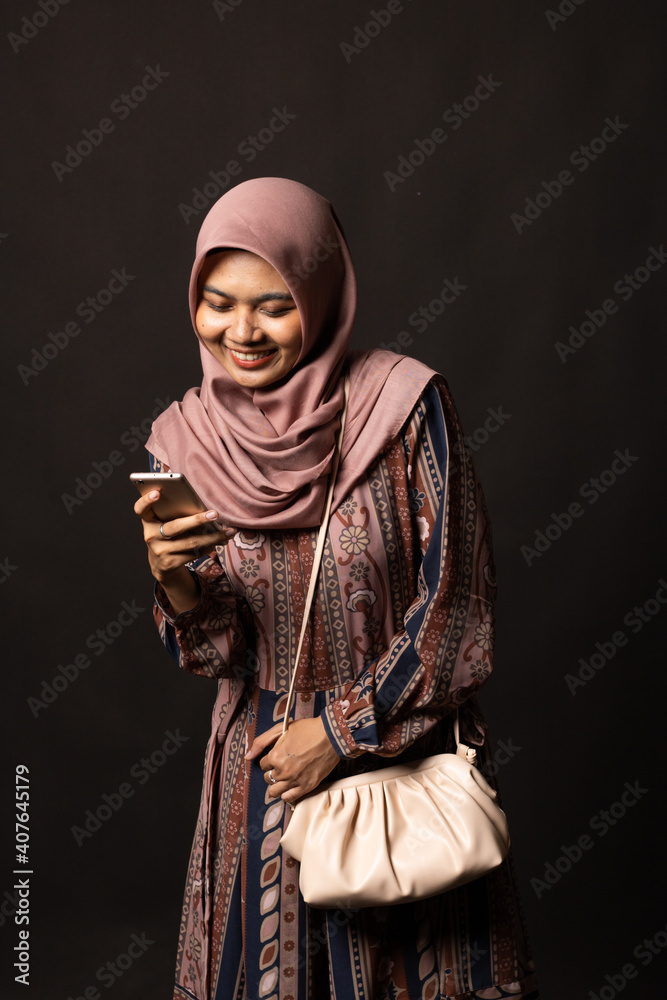 Beautiful stylish girl holding bag on black background Beautiful stylish girl holding bag on black background