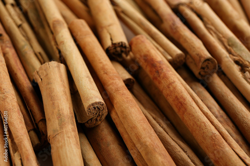 Aromatic cinnamon sticks as background, closeup view