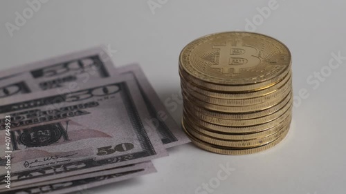 A stack of bitcoin and a wad of dollars. The concept of cryptocurrency exchange