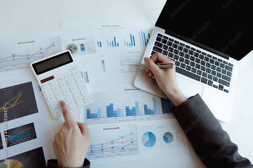 businessman working on desk office with using a calculator to calculate the numbers, finance accounting concept businessman working on desk office with using a calculator to calculate the numbers, finance accounting concept