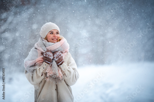 Smiling woman enjoying winter among snow outdoor