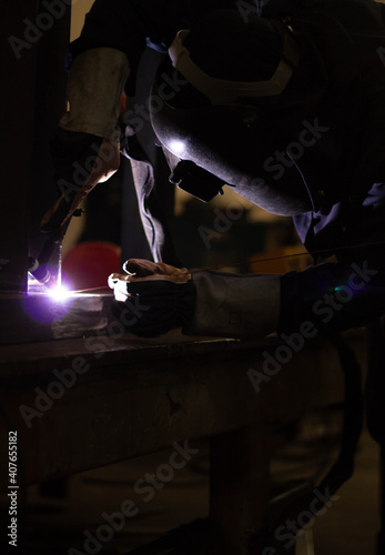 Metal workers use manual labor, Skilled welder, Factory workers making OT. Welder is welding the steel in the factory.