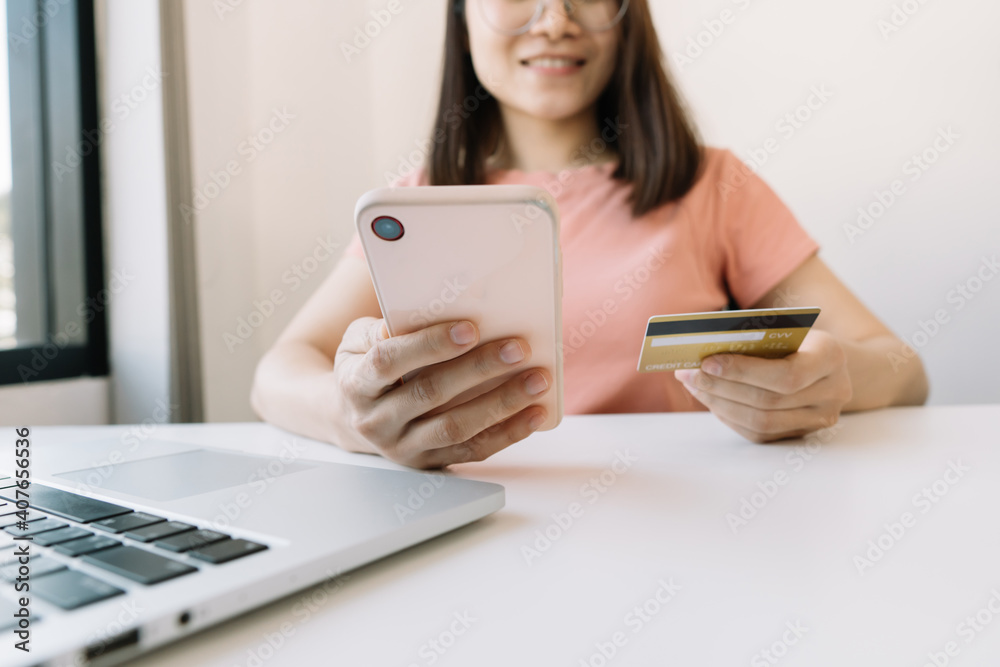 Online payment,hands holding a credit card and using smart phone for online shopping Online payment,hands holding a credit card and using smart phone for online shopping
