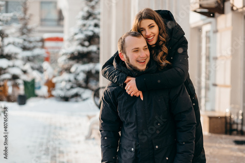 A loving couple in a gentle embrace against the background of a snowy city