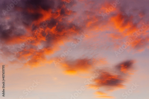 Sky and clouds in bright rainbow colors and smooth red colored sky in twilight - Perfect image as a background