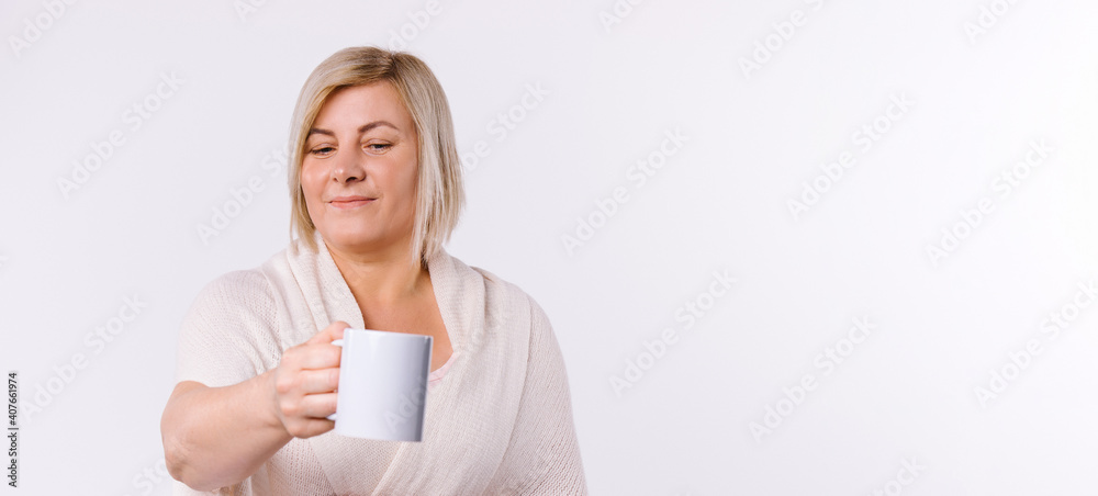 Banner. Caucasian woman holds out a cup of tea to the camera. White background and blank advertising space. Banner. Caucasian woman holds out a cup of tea to the camera. White background and blank advertising space.