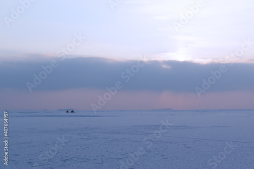 Two tents on a frozen thief. Winter fishing concept. Winter in Eastern Europe. Landscape. Horizontal orientation.