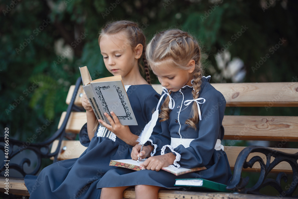 Fototapeta premium Charming little girls in retro dress walking in town on a sunny summer day