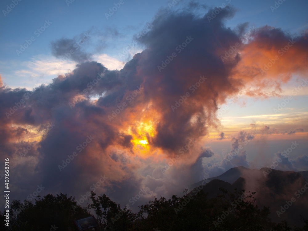 sunset in the mountains with fire in clouds