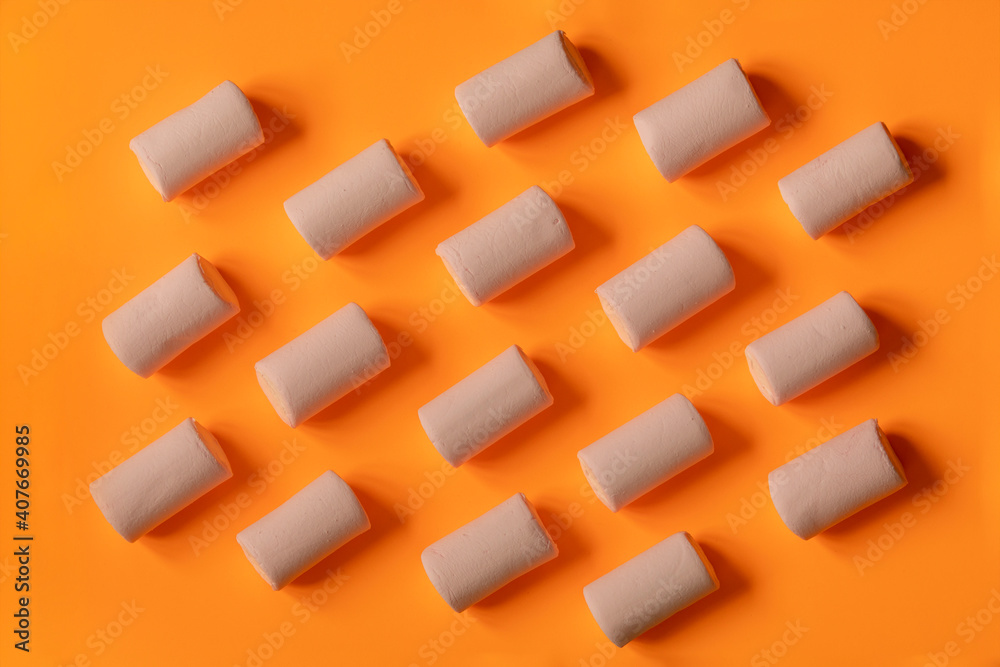 Fun marshmallows pattern for a delicious and sweet snack, on solid vibrant colored background.