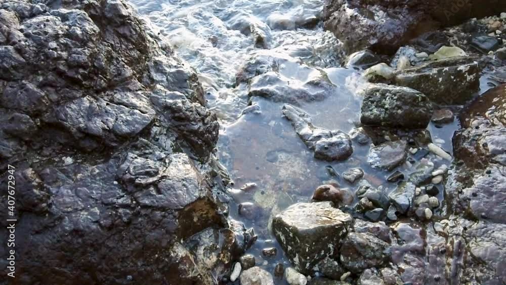 This is a High Definition close up video, 29.97 fps, of a tide pool on a Caribbean island. It shows waves flowing into and out of the pool among rocks on the shoreline of Culebra, Puerto Rico