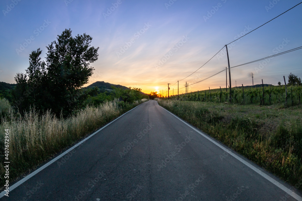country asphalt road at sunset