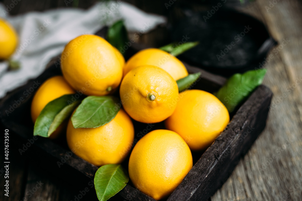 Lemons in a wooden box on a table Rustic style